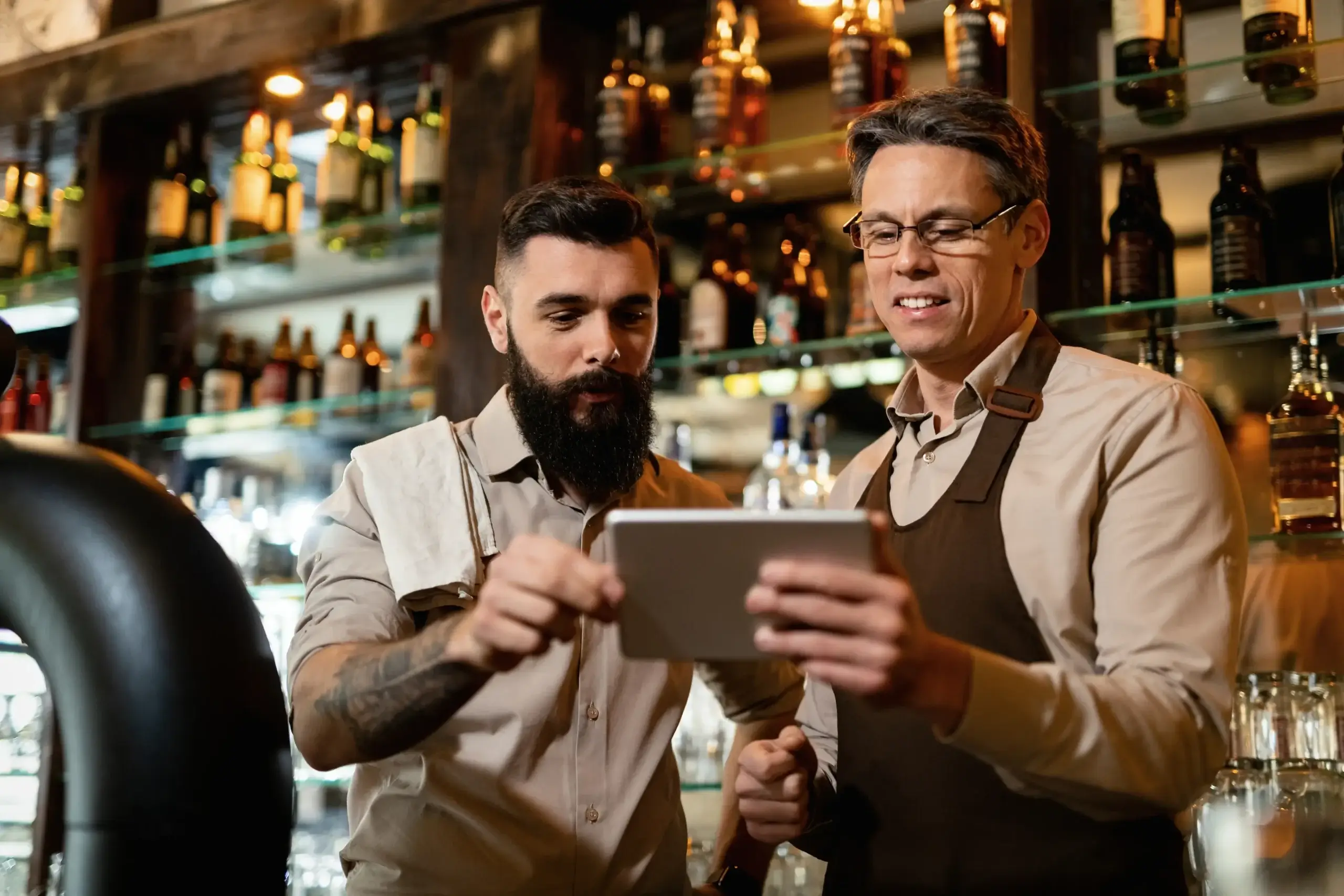 Two men talking in a bar